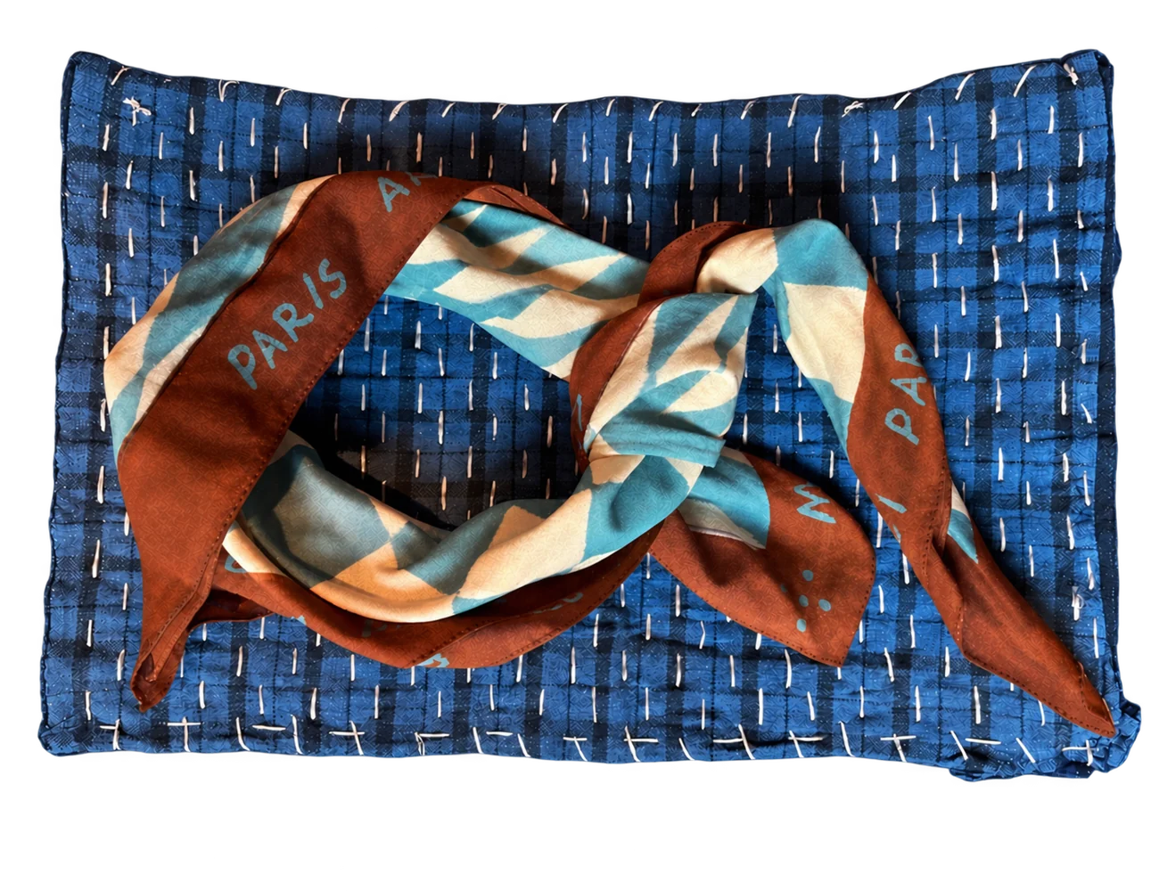 Silk scarf knotted on woven denim